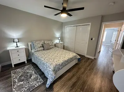 a bedroom with a bed and a ceiling fan at Suite 1 in Butler