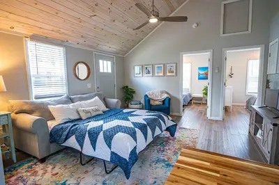 a bedroom with a bed and a couch and a tv at Renovated Retreat Home in Huron, close to beaches in Huron