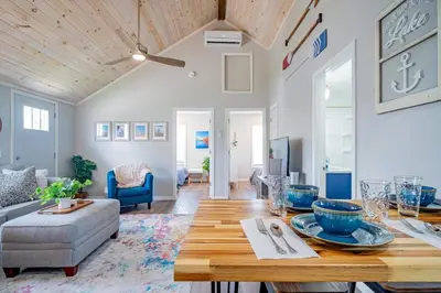 a living room with a table and a couch at Renovated Retreat Home in Huron, close to beaches in Huron