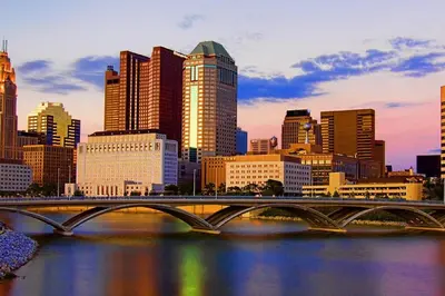 a bridge over a river in a city with buildings at The KING Apt in Downtown Columbus in Columbus