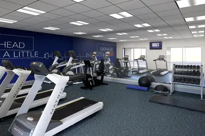 a gym with treadmills and machines in a room at Holiday Inn Express & Suites Dry Ridge by IHG in Dry Ridge