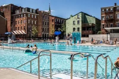 a large swimming pool with people in the water at Broadway Suites - Stunning Downtown Condos in Cincinnati