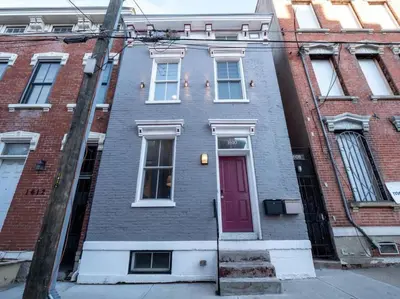 a brick house with a red door on a street at Luxury Townhome in Heart of Over the Rhine in Cincinnati