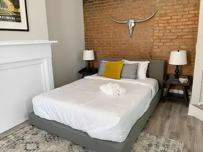 a bedroom with a bed with a towel on it at Quiet 1-Bedroom Loft near Entertainment District in Cincinnati