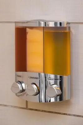 a towel dispenser on a wall in a bathroom at Stunning 2BR Apartment Near Downtown in Cincinnati