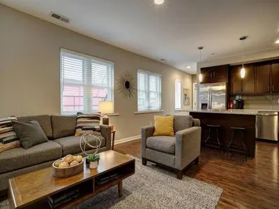 a living room with a couch and a table at Two Comfy Condos Near City Center OTR UC Zoo in Cincinnati