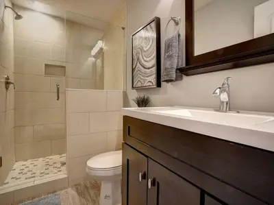 a bathroom with a sink and a toilet and a shower at Two Comfy Condos Near City Center OTR UC Zoo in Cincinnati