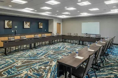 a large room with tables and chairs and a whiteboard at TownePlace Suites by Marriott Canfield in Canfield
