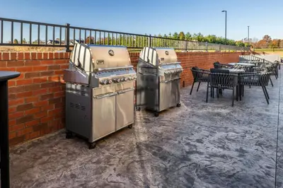 two stoves sitting on a patio next to a table at SpringHill Suites by Marriott Canfield in Canfield