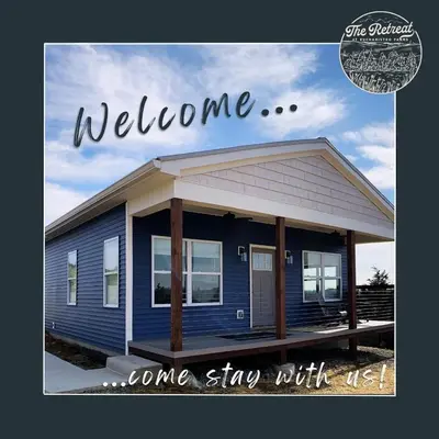 a blue house with the words welcomeone sing with us at 100 Acre Relaxing Retreat Near ARK - The Cottage in Williamstown