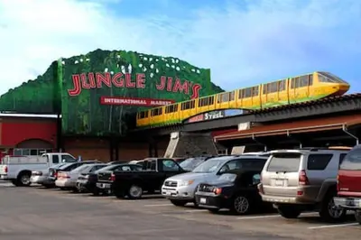 a bunch of cars parked in a parking lot with a train at Quietly nestled home among the Nook in Hamilton