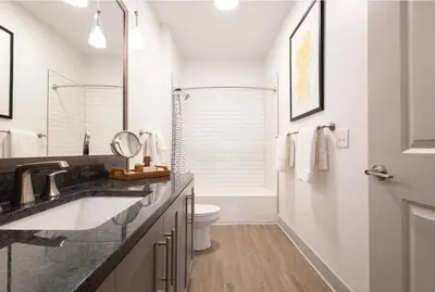 a white bathroom with a sink and a toilet at Charming 1BR 1BA Apartment Near Downtown Cincinnati in Cincinnati