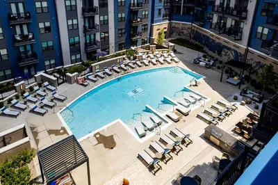 an overhead view of a large swimming pool with lounge chairs at Charming 1BR 1BA Apartment Near Downtown Cincinnati in Cincinnati