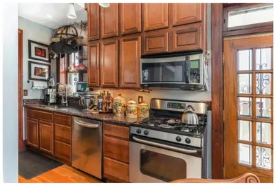 a kitchen with a stove and a microwave at Mike & Allen's Place on the Park_1 in Columbus