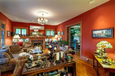 a living room with orange walls and a couch at Mike & Allen's Place on the Park_3 in Columbus
