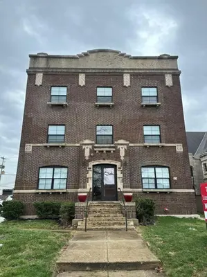 a large brick building with a front door and stairs at Modern Apartment with Pool Table! Pet-friendly! in Columbus