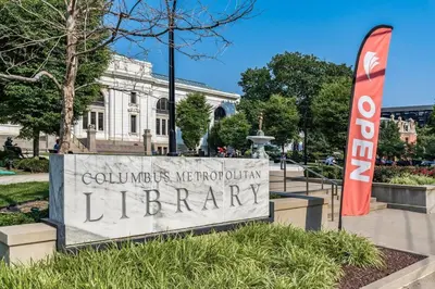 a sign for a library in front of a building at Designer 1-Bed Haven near Downtown! Pets Welcome! in Columbus