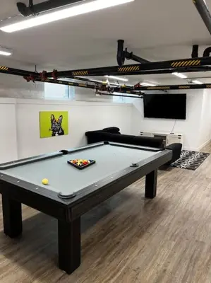 a pool table in a room with a couch at Oasis with Pool Table! Stylish Stay, Pets Allowed! in Columbus
