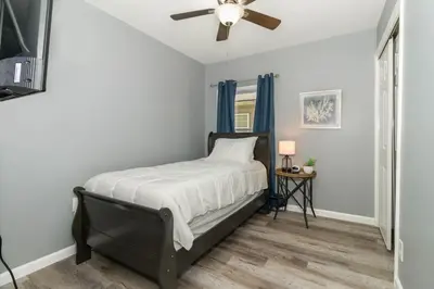 a bedroom with a bed with a ceiling fan at Furnished Ranch Home with FREE washer and dryer in Middletown
