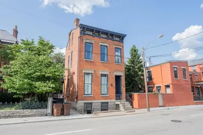 a red brick building on the corner of a street at 1BR with Kitchen & Free Parking - Walk Everywhere in Covington