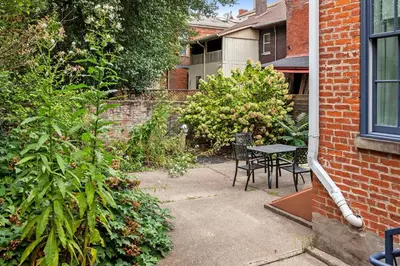 a patio with a table and chairs in a yard at 1BR with Parking - Walk to Convention Center & Stadiums in Covington