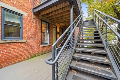 a staircase leading up to a brick building at Downtown Views - Walk to Stadiums & Convention Center in Covington