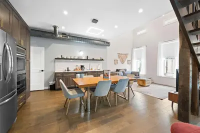 a kitchen and dining room with a table and chairs at Downtown Views - Walk to Stadiums & Convention Center in Covington