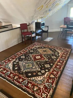 a rug on the floor in a room with a table at Awesome Attic studio3B private room /shared apt in Cincinnati