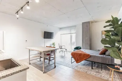a living room with a couch and a table at Downtown Chic New Studio Oasis Close to it All in Cleveland
