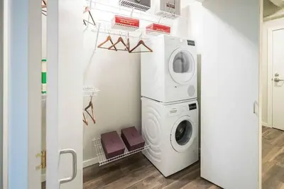 a laundry room with a washer and dryer at DT Delight Downtown Living 2bd2ba Endless Access in Cleveland
