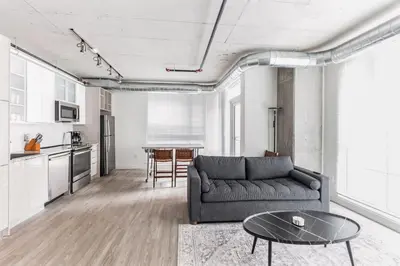 a living room with a couch and a table at DT Delight Downtown Living 2bd2ba Endless Access in Cleveland