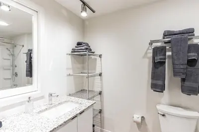 a white bathroom with a sink and a mirror at Urban Elegance Studio Oasis Prime Location in Cleveland