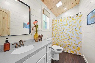 a bathroom with a toilet and a shower curtain at Block of 4 Lodges at Eden Reserve - For Groups in Williamstown