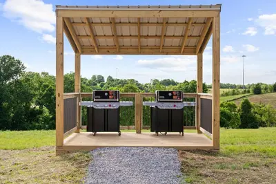 a gazebo with two burners in a field at The Lodges at Eden Reserve - Safari Tents in Williamstown