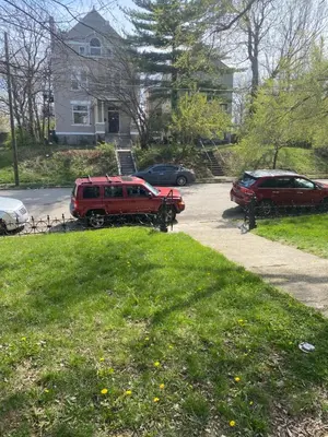 a couple of cars parked in a driveway at Second floor deluxe studio in Cincinnati