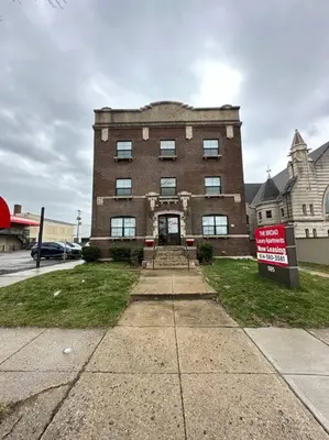 a large brick building with a sign in front of it at Columbus Gem with Pool Table! Pets Welcome! in Columbus