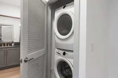 a laundry room with a washer and dryer at 2 Stylish apartments near shops and entertainment in Cincinnati