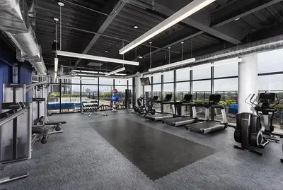 a gym with a bunch of treadmills and machines at 2 Studios apartment w prime location in Cleveland