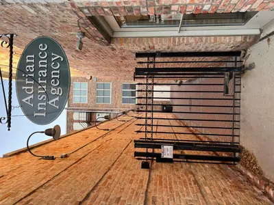 a large empty room with a metal rack on the floor at Strongback Suite 205 in Adrian