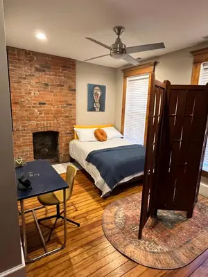 a bedroom with a bed and a brick wall at The Goodale House - 2 Units - 4 BR 5 Bath in Columbus