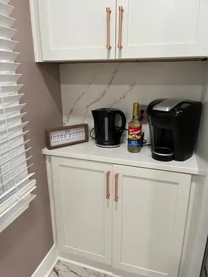 a kitchen cabinet with a coffee maker and a toaster at Sunny Lavender Canopy Retreat in Cleveland