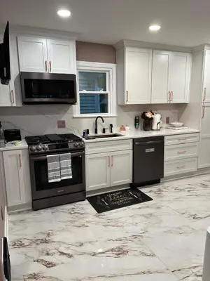 a kitchen with white cabinets and a black stove at Garden Whisper Cozy Chamber in Cleveland