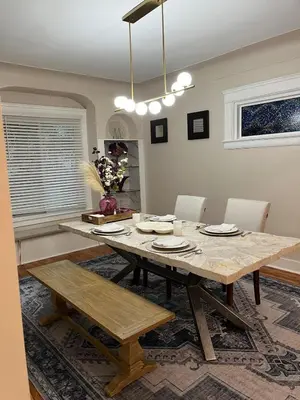a dining room with a wooden table and chairs at Stained Glass Serenity Suite in Cleveland
