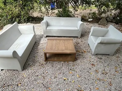 three white couches and a coffee table in a yard at Elevated Entertainment Sleep Suite in Cleveland