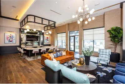 a living room with a couch and a table at Stylish apartments near shops and entertainment in Cincinnati