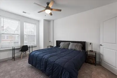a bedroom with a bed and a ceiling fan at Stylish apartments near shops and entertainment in Cincinnati