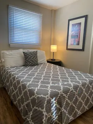 a bedroom with a bed with a gray and white comforter at Dayton with 6 Beds Sleeps 8 4 Bedrooms plus WIFI in Dayton