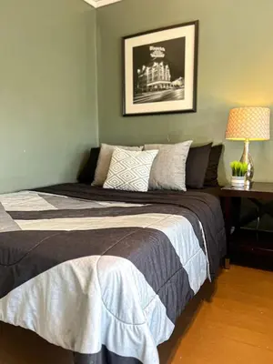 a bedroom with a bed and a table with a lamp at 3 Bedroom House, 7 Beds, Sleeps 10, Dayton in Dayton