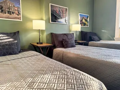 a hotel room with two beds and a couch at Sleeps up to 20 in Dayton with 6 Bedrooms plus 2 Full Kitchens in Dayton
