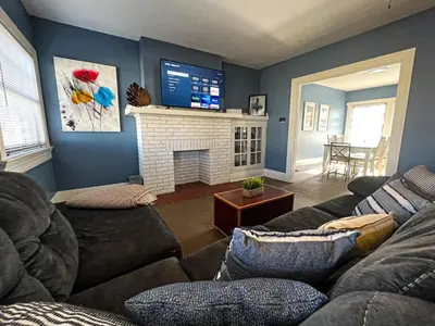 a living room with a couch and a fireplace at Sleeps up to 20 in Dayton with 6 Bedrooms plus 2 Full Kitchens in Dayton